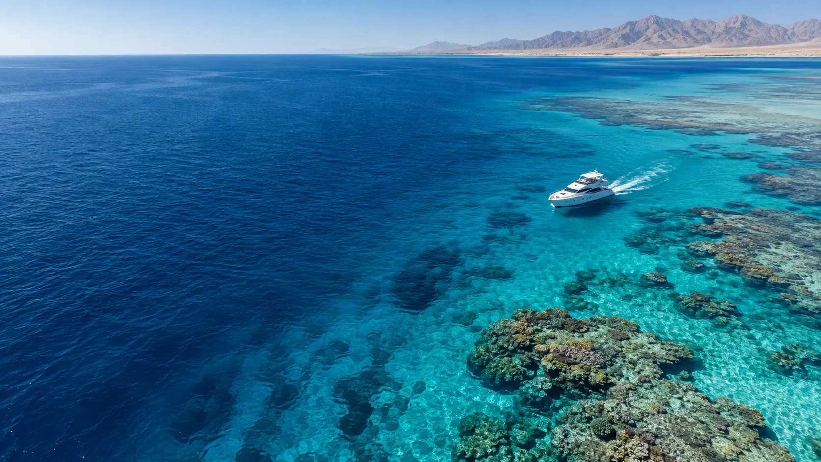 Illustrative Red Sea yacht and coral reef photograph
